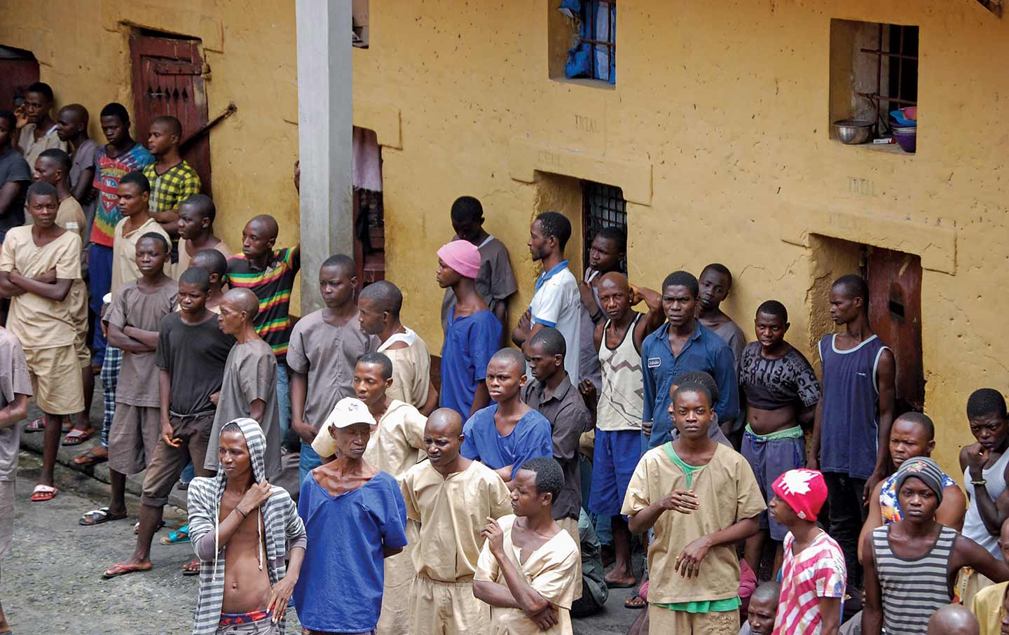 Men stand in the courtyard of the Kenema Prison, which was built in during British rule, in 1826.