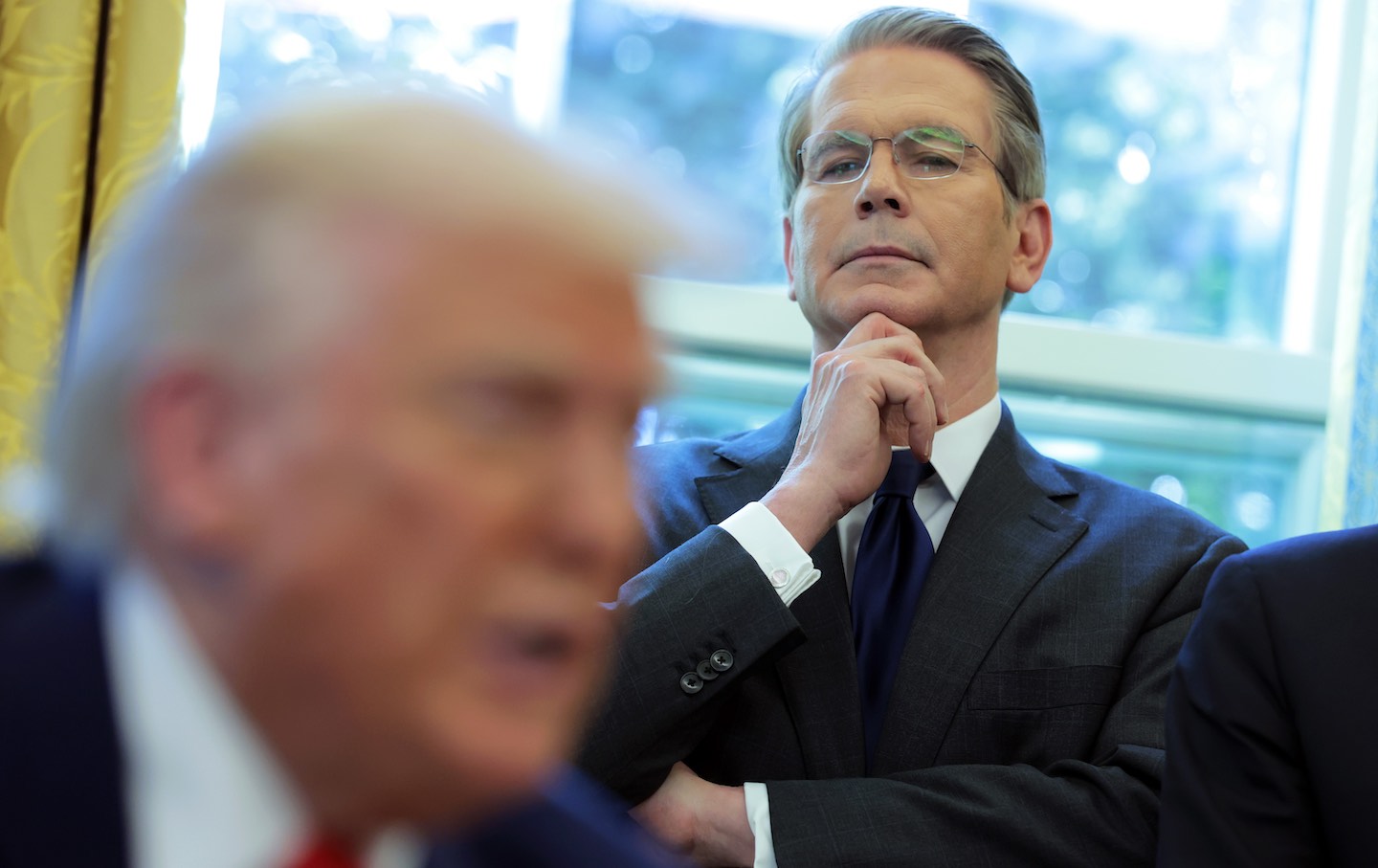 Treasury Secretary Scott Bessent looks on as President Donald Trump signs executive orders in the Oval Office on April 9, 2025.