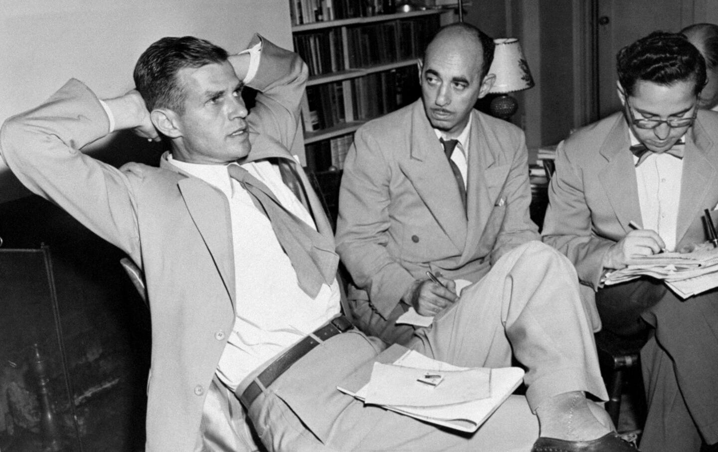 Alger Hiss, accused of spying, talks with reporters.
