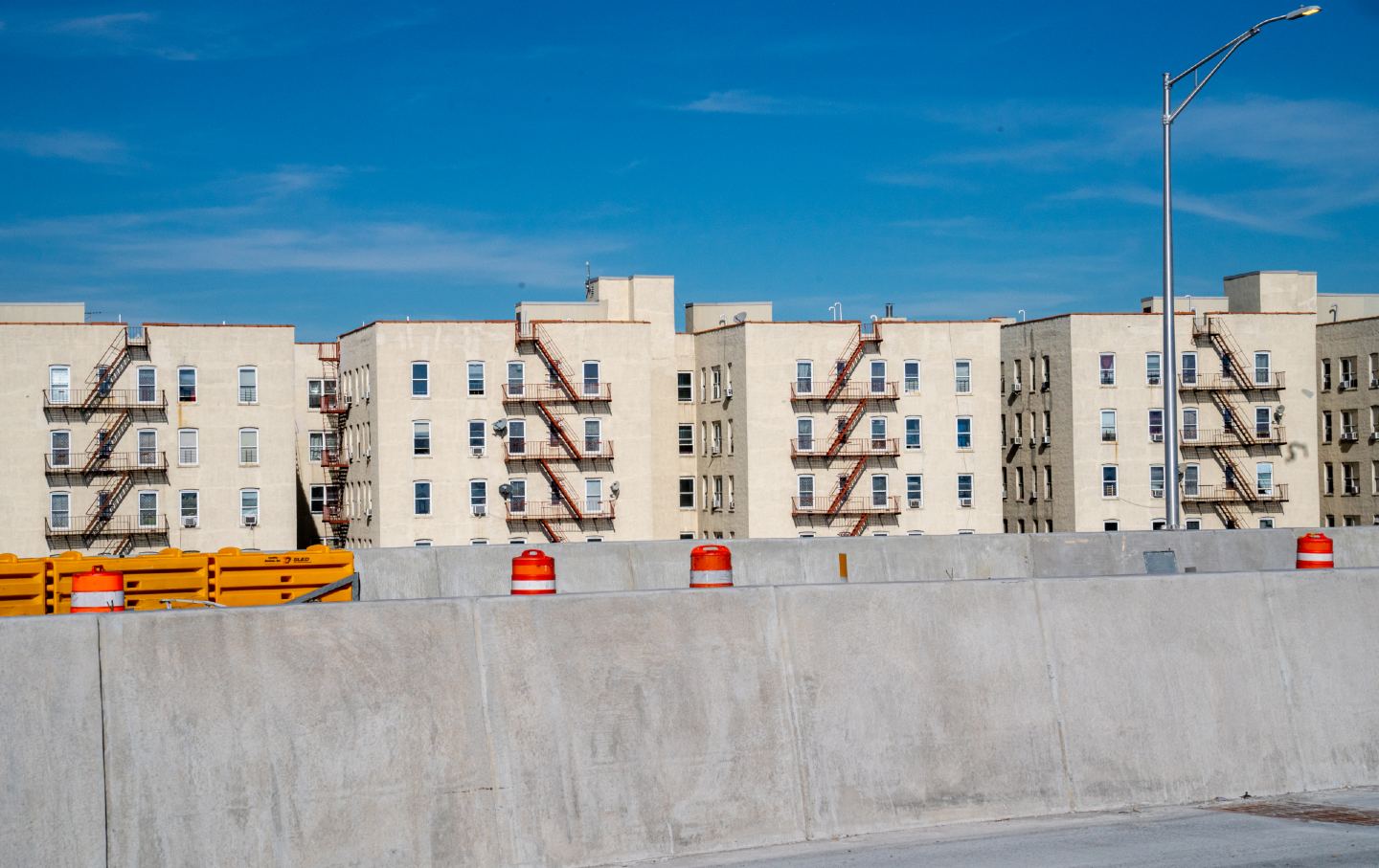 A low-income housing project sits behind roadwork being done on I-287 in the Bronx in 2022.