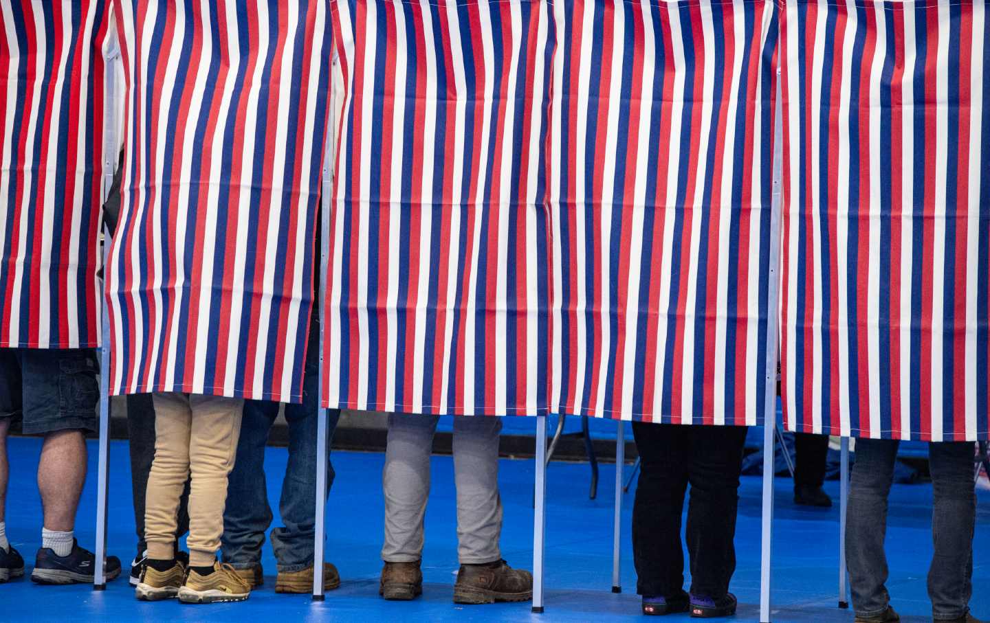 People fill out their ballots in voting booths at the Green Street Community Center in Concord, New Hampshire, on November 5, 2024.