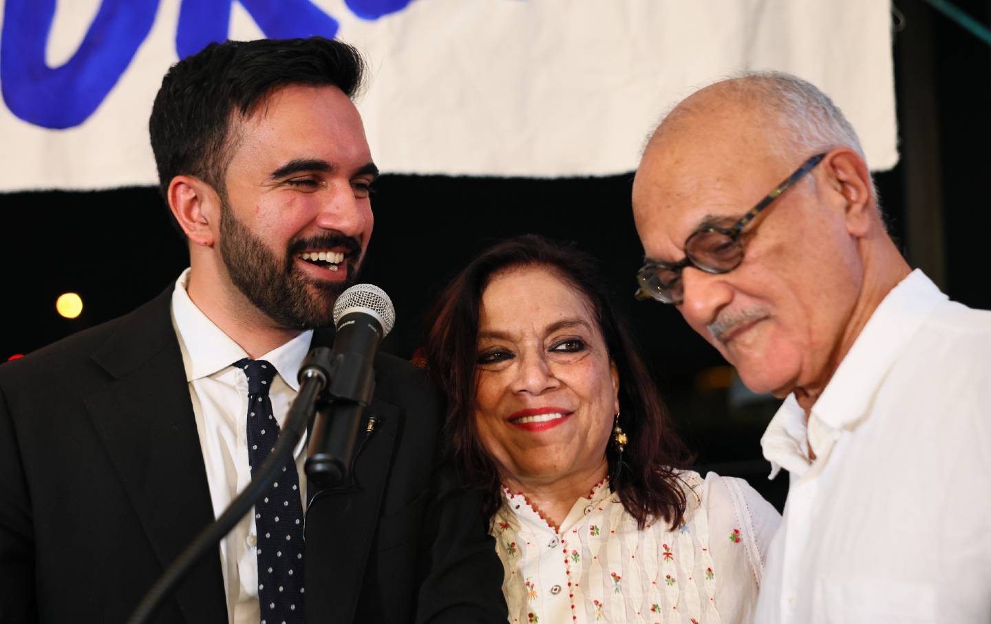 New York mayoral candidate state Assemblyman Zohran Mamdani (D-NY) stands with his mother, Mira Nair, and father, Mahmood Mamdani, as they celebrate during an election night gathering at The Greats of Craft LIC on June 24, 2025, in the Long Island City neighborhood of the Queens borough of New York City.